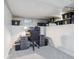 Basement office setup with computer, black desk, and storage on shelves at 3218 S Lafayette St, Englewood, CO 80113