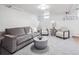 Finished basement with seating area and neutral carpet flooring at 3218 S Lafayette St, Englewood, CO 80113