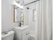 Bright bathroom with a white vanity and shower-tub combination at 3218 S Lafayette St, Englewood, CO 80113
