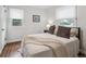 Bedroom with neutral colors, hardwood floors, and two windows at 3218 S Lafayette St, Englewood, CO 80113