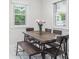 Inviting dining area featuring a wood table, bench seating, and natural light from nearby windows at 3218 S Lafayette St, Englewood, CO 80113