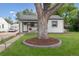 Charming single-story home with a well-maintained lawn and a beautiful tree in the front yard at 3218 S Lafayette St, Englewood, CO 80113