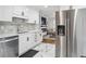 Modern kitchen with white cabinets, stainless steel appliances, and an open floor plan at 3218 S Lafayette St, Englewood, CO 80113