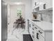 Modern kitchen with stainless steel appliances, white cabinetry, and a dining area at 3218 S Lafayette St, Englewood, CO 80113