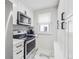Eat-in kitchen features stainless steel microwave and electric range oven at 3218 S Lafayette St, Englewood, CO 80113