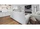 Open-concept living area with a fireplace, built-in shelves, and seamless flow to the kitchen at 3218 S Lafayette St, Englewood, CO 80113