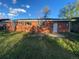 View of the backyard of a brick home with windows and a door at 106 Emerald St, Broomfield, CO 80020