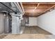 Unfinished basement with exposed utilities and a separate storage area at 7318 W Cedar Cir, Lakewood, CO 80226