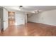 Finished basement featuring wood laminate flooring, wet bar, and ample storage at 7318 W Cedar Cir, Lakewood, CO 80226