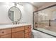 Bathroom with wood vanity and tiled shower at 7318 W Cedar Cir, Lakewood, CO 80226