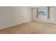 Bedroom with beige carpet, neutral walls, and window with curtains at 7318 W Cedar Cir, Lakewood, CO 80226