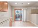 Eat in kitchen area with sliding door to outside area and neutral tile floor at 7318 W Cedar Cir, Lakewood, CO 80226