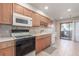 Bright kitchen with oak cabinets, stainless steel appliances, and tile flooring at 7318 W Cedar Cir, Lakewood, CO 80226