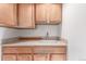 Sink and counter area in kitchen with oak cabinets and light colored counter at 7318 W Cedar Cir, Lakewood, CO 80226