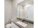 Clean bathroom featuring a white vanity with countertop, mirror, and tile-surround shower at 2985 Oxley St, Strasburg, CO 80136