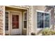 Charming entryway with stone detailing, a storm door, and a bright window with privacy blinds at 10165 E Carolina Pl # 102, Aurora, CO 80247