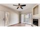 Bright living room featuring wood floors, ceiling fan, and sliding glass doors to a private patio at 10165 E Carolina Pl # 102, Aurora, CO 80247
