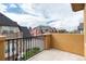 Exterior shot from balcony of surrounding townhomes, blue skies, and metal railing at 7777 E 23Rd Ave # 201, Denver, CO 80238