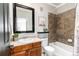 Well-appointed bathroom with a vanity, tub/shower combo, and neutral tile at 7777 E 23Rd Ave # 201, Denver, CO 80238