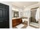 Beautiful bathroom featuring a double sink vanity, soaking tub, glass shower, and neutral tile at 7777 E 23Rd Ave # 201, Denver, CO 80238