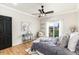 Bright bedroom featuring wood floors, a sliding door to a patio, a plush bed and gray accents at 7777 E 23Rd Ave # 201, Denver, CO 80238
