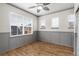 Cozy bedroom with panelled walls, three windows and wood flooring at 7777 E 23Rd Ave # 201, Denver, CO 80238