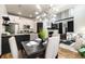 Contemporary dining room with striking chandelier, open to modern kitchen and fireplace, with hardwood flooring at 7777 E 23Rd Ave # 201, Denver, CO 80238