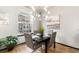Stylish dining area with modern lighting and a view to the outside at 7777 E 23Rd Ave # 201, Denver, CO 80238
