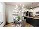 Stylish dining area with modern lighting and a view to the kitchen at 7777 E 23Rd Ave # 201, Denver, CO 80238