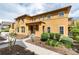 Inviting two-story stucco home with landscaped front yard, walkway to entrance, and sunlit windows at 7777 E 23Rd Ave # 201, Denver, CO 80238