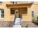 Charming covered front porch with wrought iron railing, providing curb appeal to this home at 7777 E 23Rd Ave # 201, Denver, CO 80238