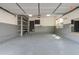 Spacious two car garage featuring painted walls, overhead lighting, and room for storage at 7777 E 23Rd Ave # 201, Denver, CO 80238