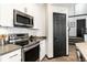 Stylish kitchen features stainless steel appliances and modern white cabinetry at 7777 E 23Rd Ave # 201, Denver, CO 80238