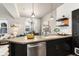 Open-concept kitchen and dining area with sleek countertops and modern finishes at 7777 E 23Rd Ave # 201, Denver, CO 80238