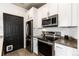 Well-equipped kitchen with stainless steel appliances and sleek countertops at 7777 E 23Rd Ave # 201, Denver, CO 80238