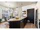 Open-concept kitchen and dining area with sleek countertops and modern finishes at 7777 E 23Rd Ave # 201, Denver, CO 80238