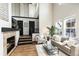 Bright living room features a cozy fireplace, high ceilings, and natural light at 7777 E 23Rd Ave # 201, Denver, CO 80238