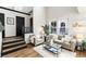 Cozy living room with high ceilings, natural light, and a comfortable seating area with modern accents at 7777 E 23Rd Ave # 201, Denver, CO 80238