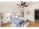Comfortable main bedroom with wood floors and ceiling fan at 7777 E 23Rd Ave # 201, Denver, CO 80238
