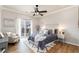 Inviting main bedroom with wood floors, ceiling fan, and sliding doors at 7777 E 23Rd Ave # 201, Denver, CO 80238