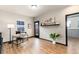 Bright home office with wood floors, desk, and a door leading to an outdoor space at 7777 E 23Rd Ave # 201, Denver, CO 80238