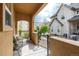 Inviting covered porch with view of neighborhood, perfect for relaxation and enjoying the outdoors at 7777 E 23Rd Ave # 201, Denver, CO 80238