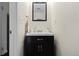 Stylish powder bathroom with dark wood vanity, rectangular mirror, and decorative accents at 10886 Bayfield Way, Parker, CO 80138