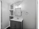 Updated bathroom featuring gray vanity, shelves, a mirrored medicine cabinet, and modern fixtures at 10886 Bayfield Way, Parker, CO 80138