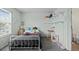 Bedroom with twin bed, shelves, and cute decor near an ensuite bathroom at 10886 Bayfield Way, Parker, CO 80138