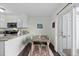 Cozy dining area adjacent to the kitchen with ample natural light and modern decor at 10886 Bayfield Way, Parker, CO 80138