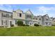 Beautiful townhomes on a lush green lawn beneath a bright blue sky at 10886 Bayfield Way, Parker, CO 80138