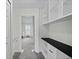 Neutral hallway with built-in shelves and access to carpeted room with natural light at 10886 Bayfield Way, Parker, CO 80138