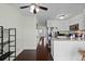 Bright kitchen featuring stainless steel appliances, white cabinets, and a peninsula island at 10886 Bayfield Way, Parker, CO 80138
