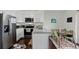 Bright, modern kitchen with white cabinets, stainless steel appliances, and stylish dining area at 10886 Bayfield Way, Parker, CO 80138